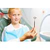 Cute smiling girl in at dentist sitting in armchair