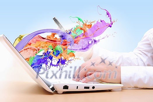 Close up of man's hands using laptop and splashes out of monitor Close up of man's hands using laptop and splashes out of monitor