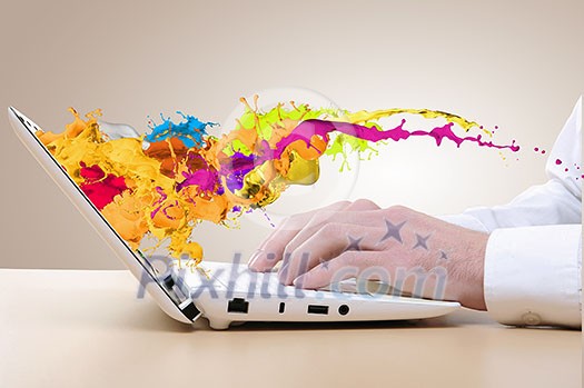 Close up of man's hands using laptop and splashes out of monitor Close up of man's hands using laptop and splashes out of monitor