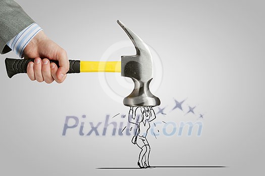 Close up of hand hitting businesswoman with hammer Close up of hand hitting businesswoman with hammer