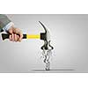 Close up of hand hitting businesswoman with hammer