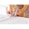 Close up of dressmaker at work making patterns of fabric