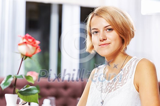 Portrait of young pretty woman sitting at cafe Portrait of young pretty woman sitting at cafe