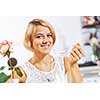 Portrait of young pretty woman sitting at cafe and eating dessert