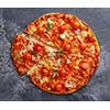 Slice of pepperoni pizza with cherry tomatoes. Sliced tasty pepperoni pizza on the grey stone background. Top view.