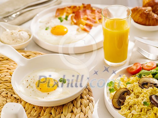 Morning breakfast with egg, bacon and orange juice. Fried eggs sunny side up. Morning breakfast with egg, bacon and orange juice. Fried eggs sunny side up.