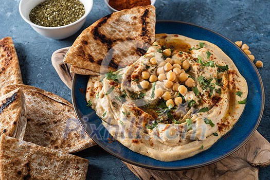 Classic Hummus with chickpeas, paprika, olive oil and oriental spices. Mediterranean popular snack of chickpeas and tahini pasta. Classic Hummus with chickpeas, paprika, olive oil and oriental spices. Mediterranean popular snack of chickpeas and tahini pasta.