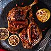 Duck leg confit with rice and goji berries. Traditional french cuisine. View from above.