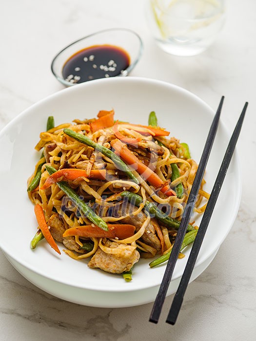 Asian noodles with pork in teriyaki sauce, with green beans, carrots and shiitake mushrooms Asian noodles with pork in teriyaki sauce, with green beans, carrots and shiitake mushrooms