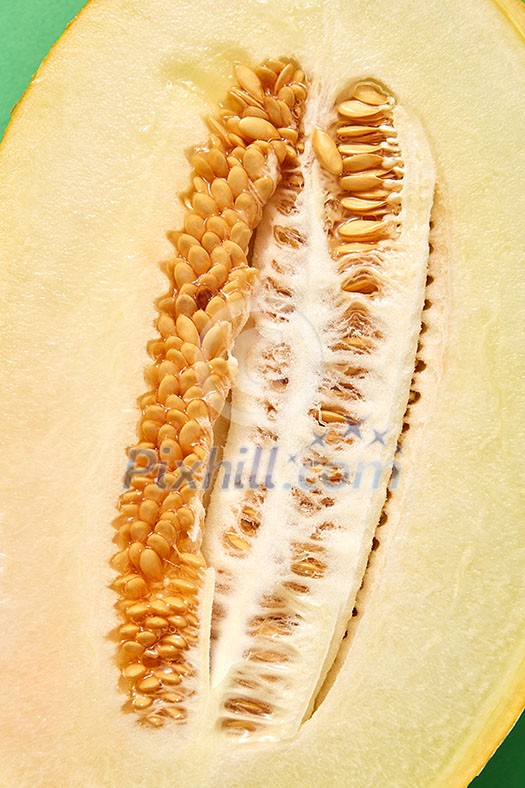 Fresh ripe organic melon cut of half with seeds, close up background. Top view. Fresh ripe organic melon cut of half with seeds, close up background. Top view.