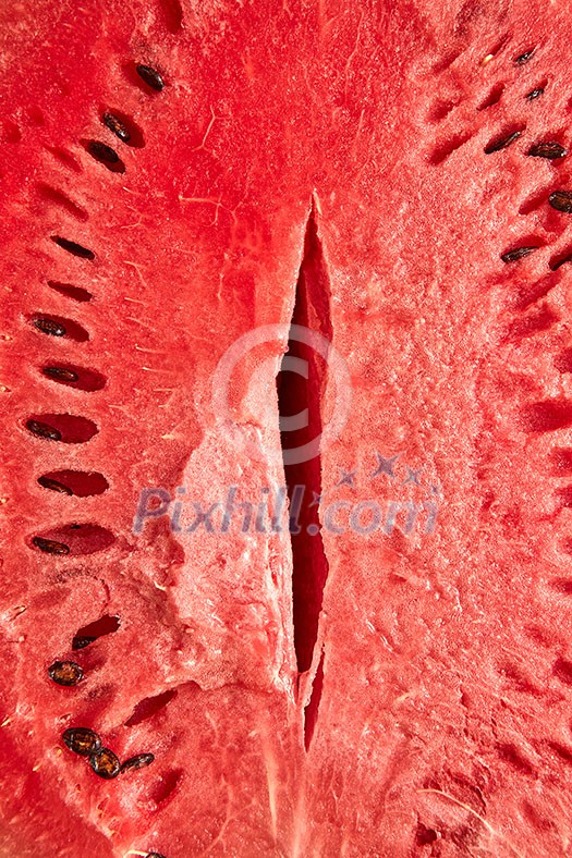 Fresh ripe organic watermelon cut with seeds as an erotic vagina symbol background. Fresh ripe organic watermelon cut with seeds as an erotic vagina symbol background.