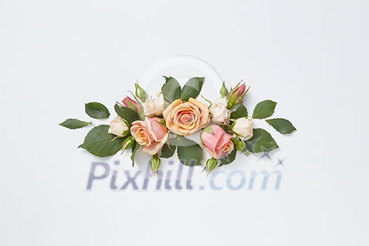 Romantic congratulation card with blooming roses flowers and green leaves on a light grey background, copy space. Valentine's Day concept. Romantic congratulation card with blooming roses flowers and green leaves on a light grey background, copy space. Valentine's Day concept.