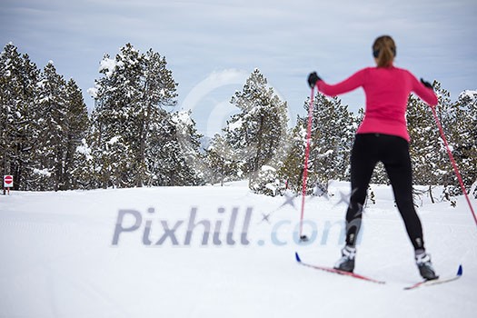 Cross-country skiing: young woman cross-country skiing on a winter day Cross-country skiing: young woman cross-country skiing on a winter day