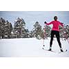 Cross-country skiing: young woman cross-country skiing on a winter day