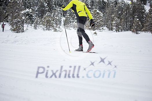 Cross-country skiing: young man cross-country skiing on a winter day