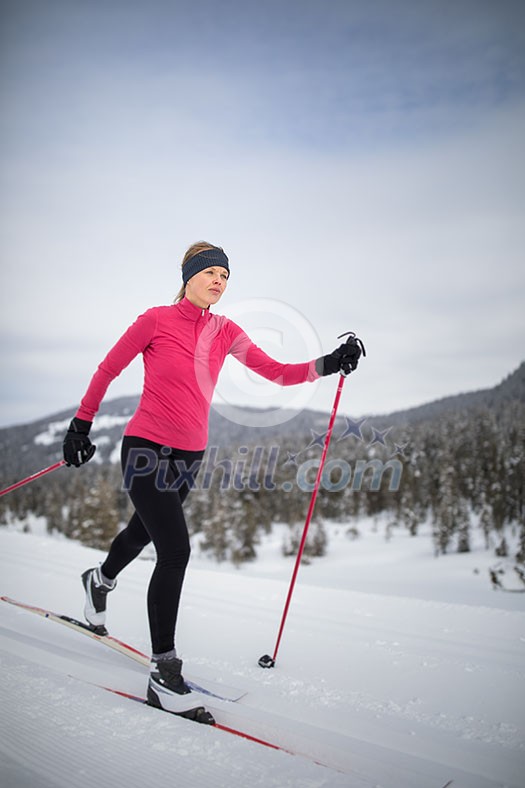 Cross-country skiing: young woman cross-country skiing on a winter day (motion blurred image) Cross-country skiing: young woman cross-country skiing on a winter day (motion blurred image)