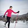 Cross-country skiing: young woman cross-country skiing on a winter day (motion blurred image)