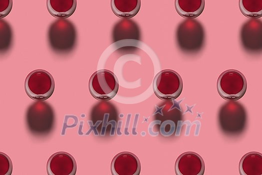 Rows with glasses of red wine alcohol drink on a pink background with hard shadows. Top view. Alcohol drink pattern. Rows with glasses of red wine alcohol drink on a pink background with hard shadows. Top view. Alcohol drink pattern.