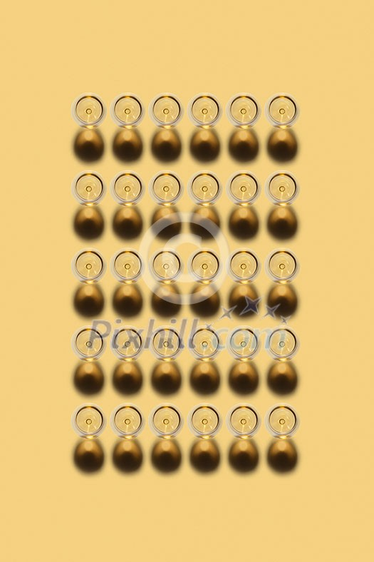 Top view above rectangular alcohol pattern from transparent glasses with white wine on a light yellow background, copy space. Top view. Top view above rectangular alcohol pattern from transparent glasses with white wine on a light yellow background, copy space. Top view.
