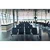 Modern airport terminal with empty arm-chairs for waiting departure. Travel and transportation concept.