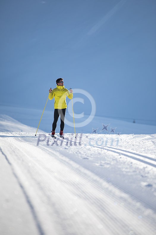 Cross-country skiing: young man cross-country skiing on a winter day Cross-country skiing: young man cross-country skiing on a winter day