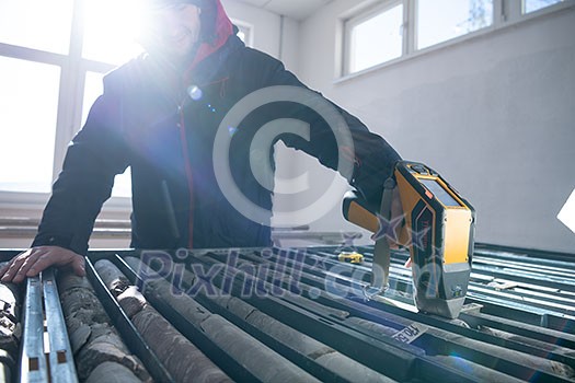 geological gold core samples with team of mining workers measuring drilled rock geological gold core samples with team of mining workers measuring drilled rock