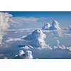 Bright clear blue sky covered white fluffy cumulus clouds in a summer sunny day with copy space. Travel and tourism concept.