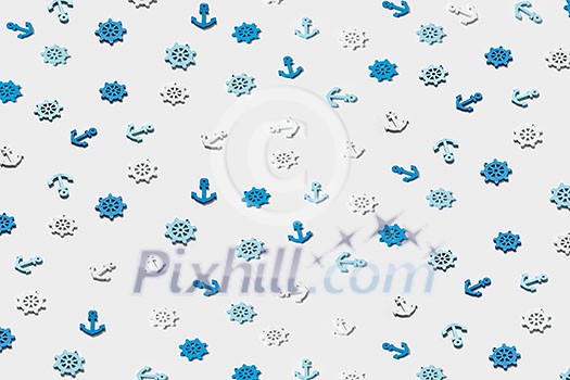 Decorative pattern from ship's marine symbols plastic anchors and steering wheels on a light grey background. Decorative pattern from ship's marine symbols plastic anchors and steering wheels on a light grey background.