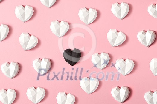 Horizontal holiday pattern from plaster white hearts and one is black on a pastel pink background with soft shadows. Valentine's day greeting card. Horizontal holiday pattern from plaster white hearts and one is black on a pastel pink background with soft shadows. Valentine's day greeting card.