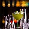 Alcoholic cocktail of green color on a bar counter. Cucumber cocktail.