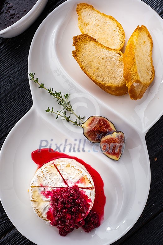Baked Brie cheese with honey and thyme. Served with Cumberland Sauce and Crunchy Croutons Baked Brie cheese with honey and thyme. Served with Cumberland Sauce and Crunchy Croutons