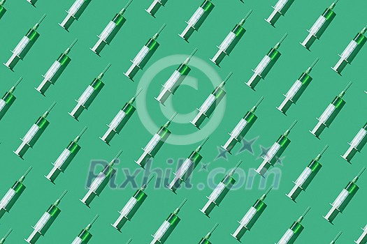 Healthcare horizontal pattern from sterile disposable plastic needles with green liquid or vaccine on light green background with hard shadows. Flat lay. Healthcare horizontal pattern from sterile disposable plastic needles with green liquid or vaccine on light green background with hard shadows. Flat lay.
