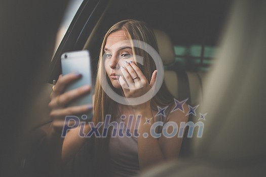 Cute teenage girl in a car, enjoying the ride
