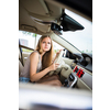 Cute female teen driver enjoying her freshly acquired driving license at the wheel of her first car