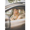 Cute female teen driver enjoying her freshly acquired driving license at the wheel of her first car