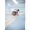 professional carpenter installing new laminated wooden floor in a unfinished apartment