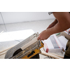 professional worker cutting plank with electrical circular saw during installation a new laminated wooden floor in a unfinished apartment