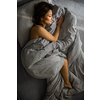 Pretty, young woman in her bed, fast asleep. Importance of sleep concept
