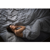 Pretty, young woman in her bed, fast asleep. Importance of sleep concept