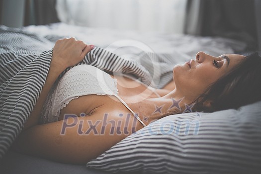 Pretty, young woman in her bed, fast asleep. Importance of sleep concept Pretty, young woman in her bed, fast asleep. Importance of sleep concept