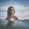 Pretty, young woman enjoying a day at the beach, relaxing on inflatable mattress