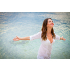 Woman relaxing at the beach with arms open enjoying her freedom,  independence, good health, time off.