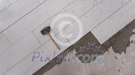 Ceramic wood effect tiles and tools for tiler on the floor unfinished laying floor tiles Floor tiles installation Ceramic wood effect tiles and tools for tiler on the floor unfinished laying floor tiles Floor tiles installation