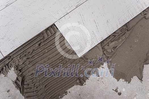 Ceramic wood effect tiles and tools for tiler on the floor unfinished laying floor tiles Floor tiles installation Ceramic wood effect tiles and tools for tiler on the floor unfinished laying floor tiles Floor tiles installation