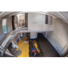 Laborer performing and polishing sand and cement screed floor on the construction site of a new two-level apartment. Sand and cement floor screed