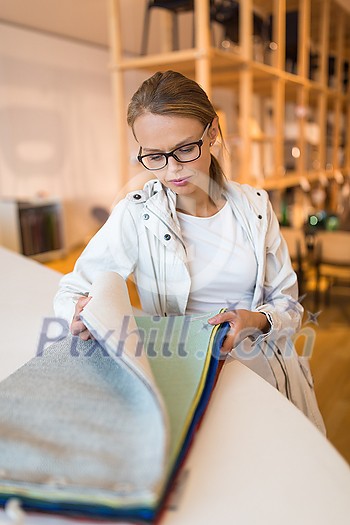 Pretty young woman choosing the right material/color for her modern appartement interior (shallow DOF; color toned image) Pretty young woman choosing the right material/color for her modern appartement interior (shallow DOF; color toned image)