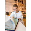 Pretty young woman  choosing the right material/color for her modern appartement interior (shallow DOF; color toned image)
