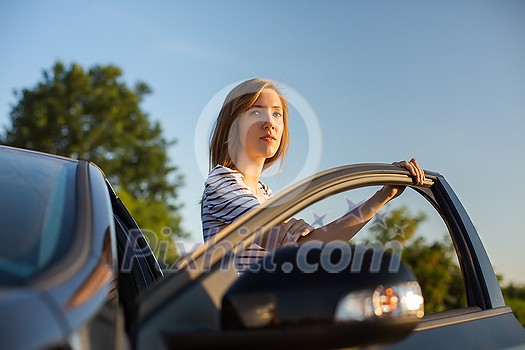 Pretty, young woman driving her car Pretty, young woman driving her car