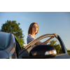 Pretty, young woman driving her car