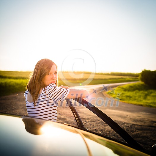 Pretty, young woman driving her car Pretty, young woman driving her car